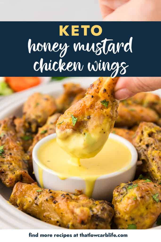 Wing being dipped in low carb honey mustard.