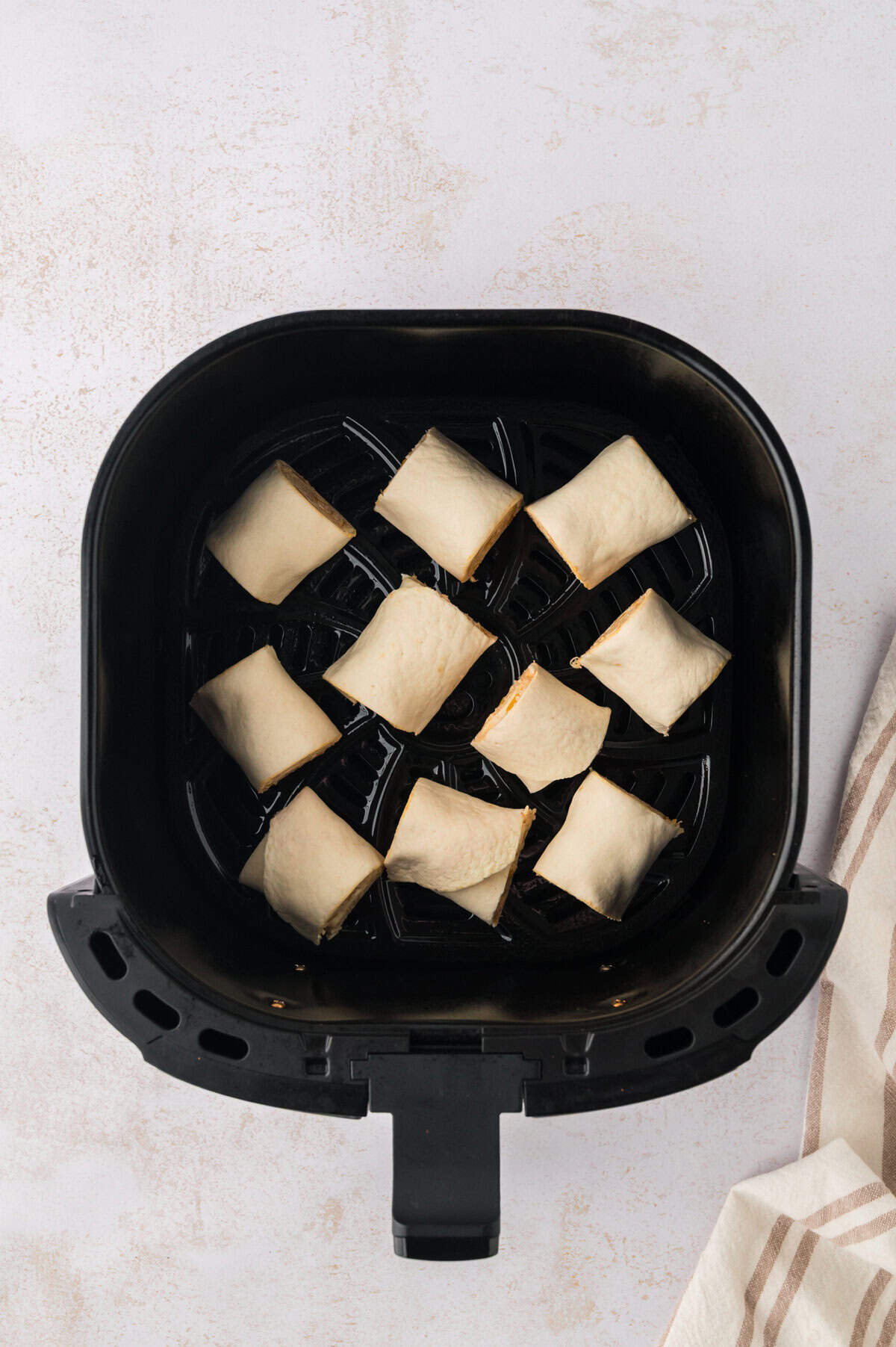 Tortilla pinwheels in air fryer basket.