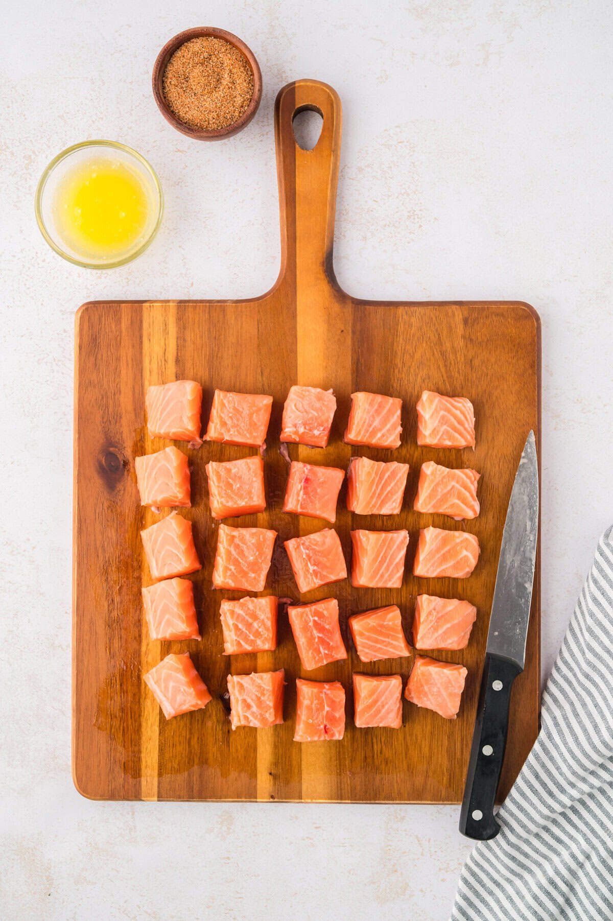 Cubed salmon on cutting board.