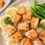 Plate topped with cubed salmon, green beans, and cauliflower rice.