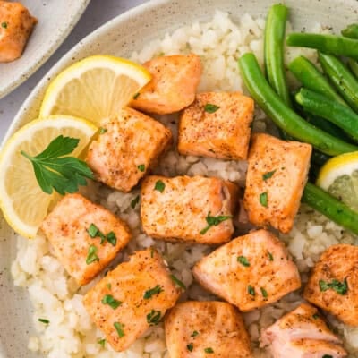 Plate topped with cubed salmon, green beans, and cauliflower rice.