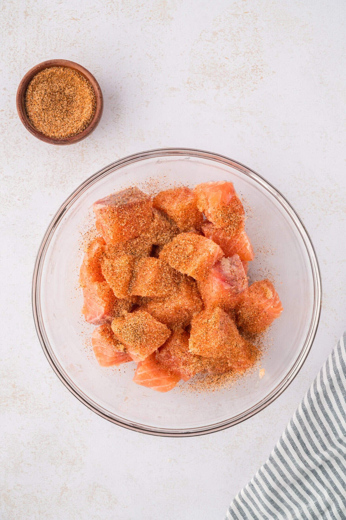 Seasoned salmon bites in bowl.