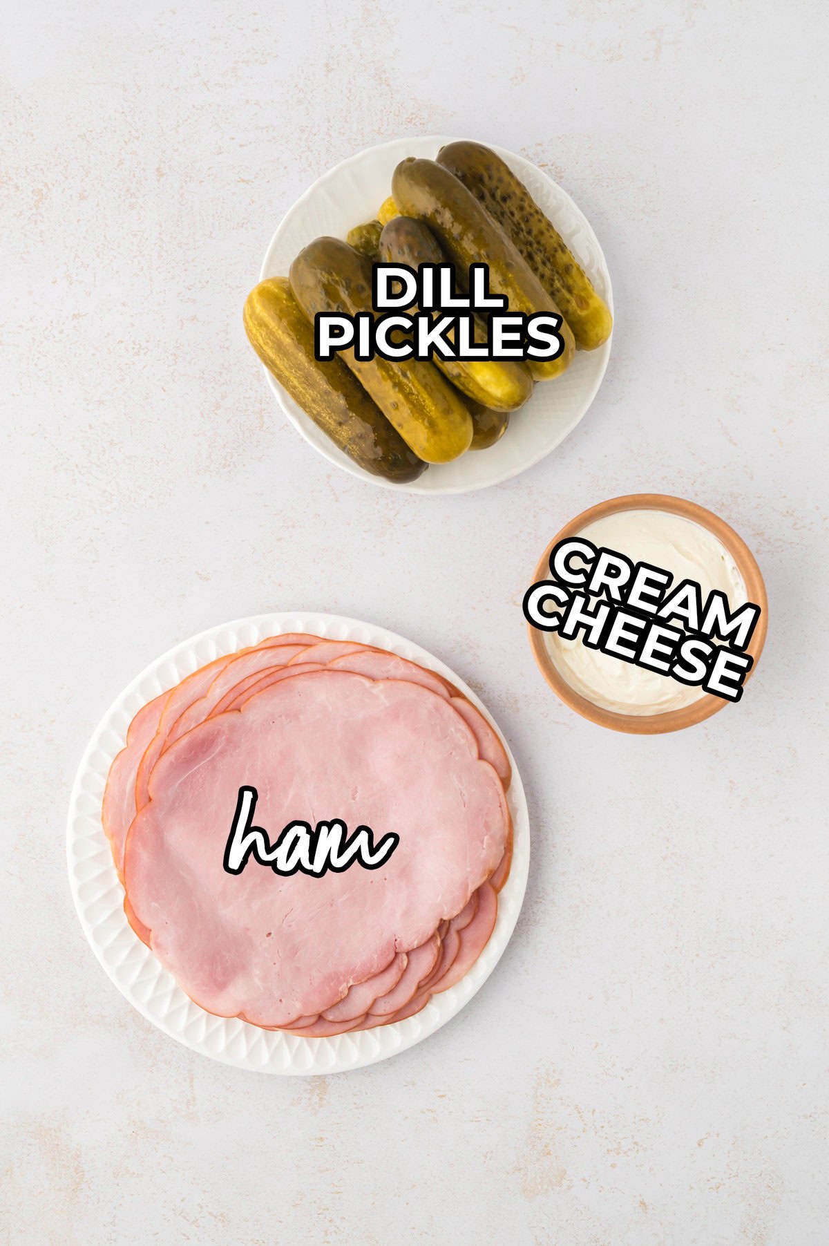 Ingredients for keto ham and pickle roll ups on counter.