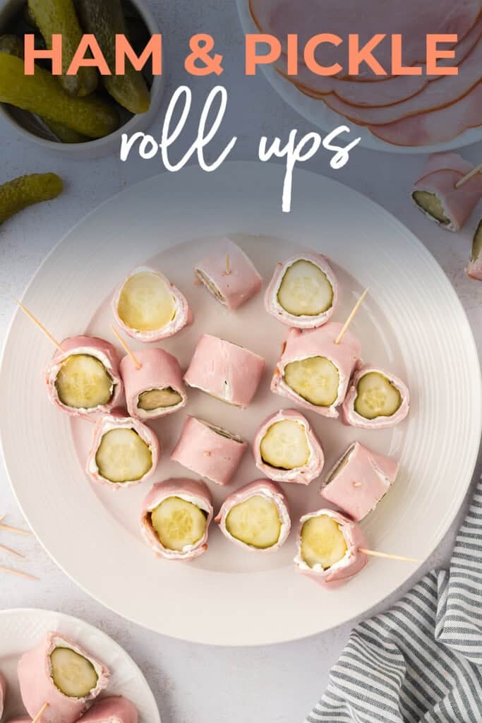 Overhead view of pickles and cream cheese rolled up in deli ham.