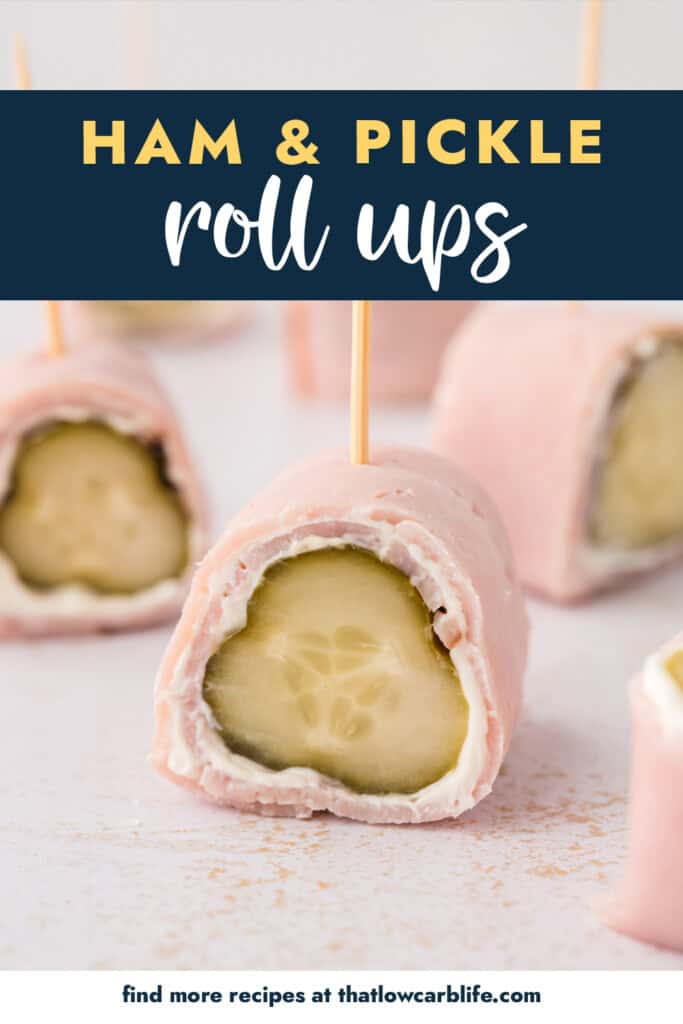 Ham and pickle roll up with a toothpick on plate.