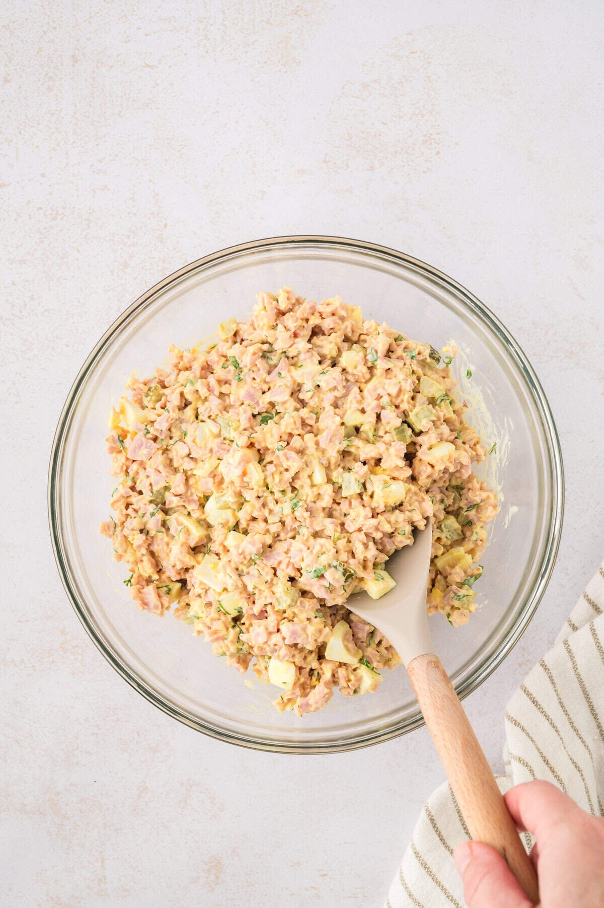 Ham salad with pickles in mixing bowl.