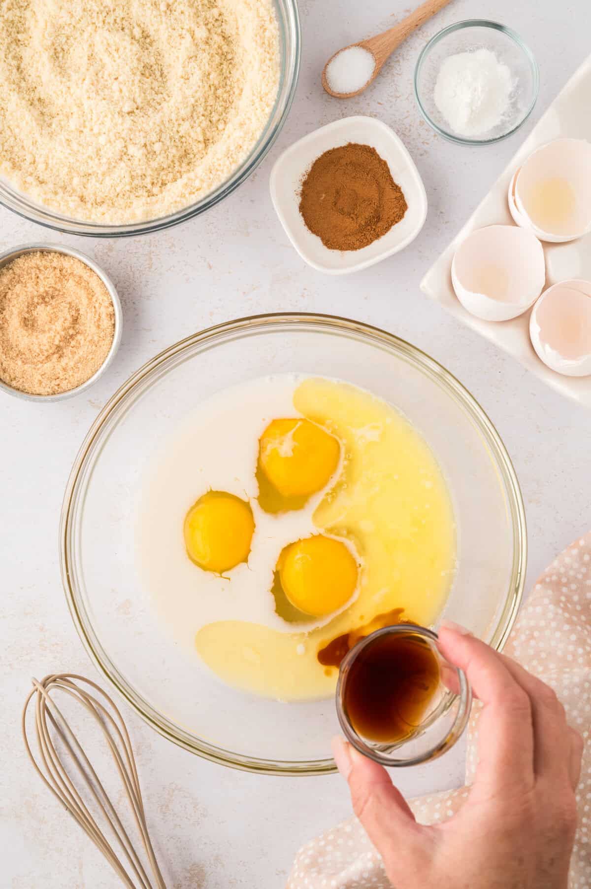 Eggs, almond milk, and vanilla in mixing bowl.