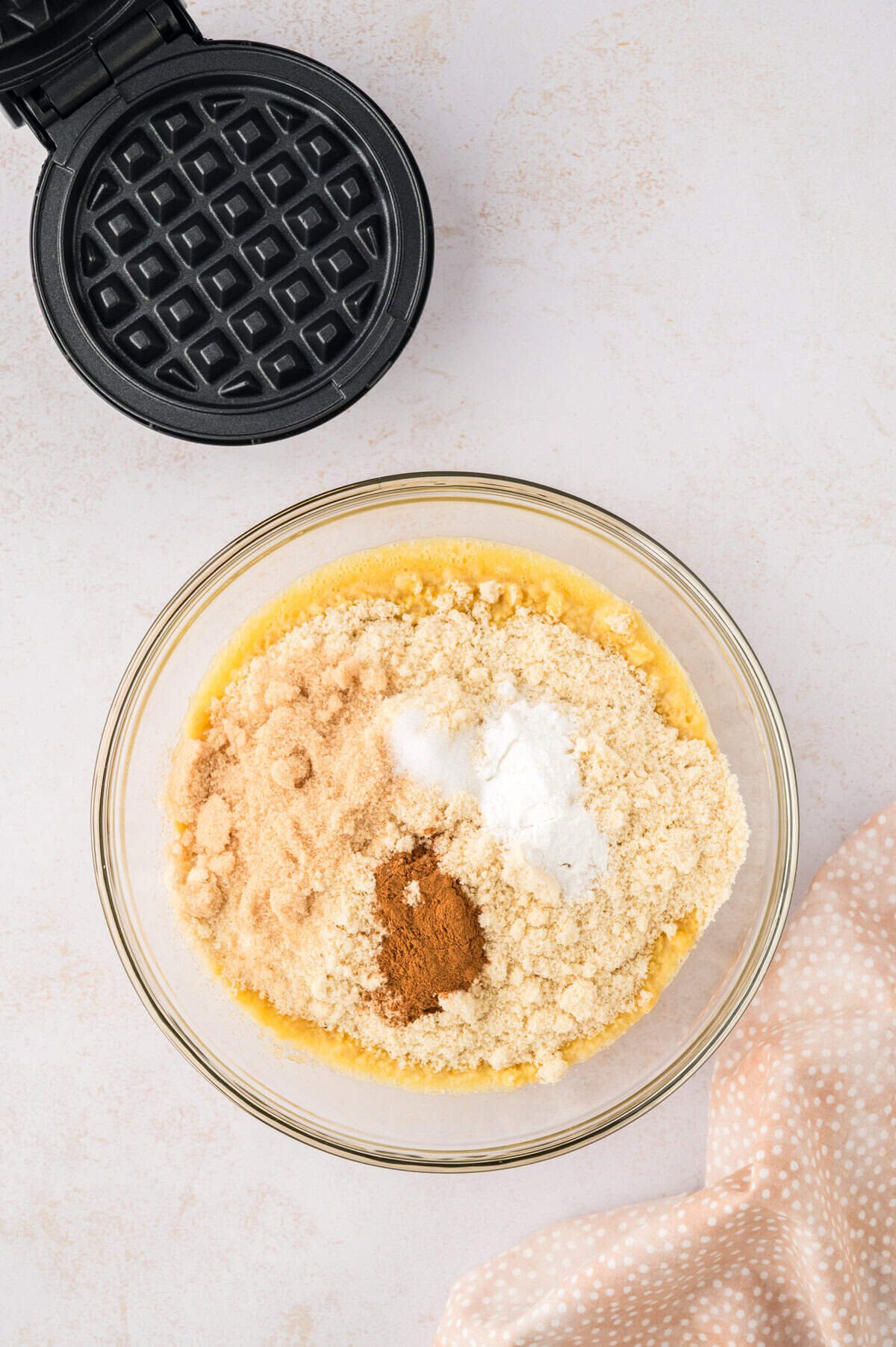 Dry ingredients added to waffle batter.
