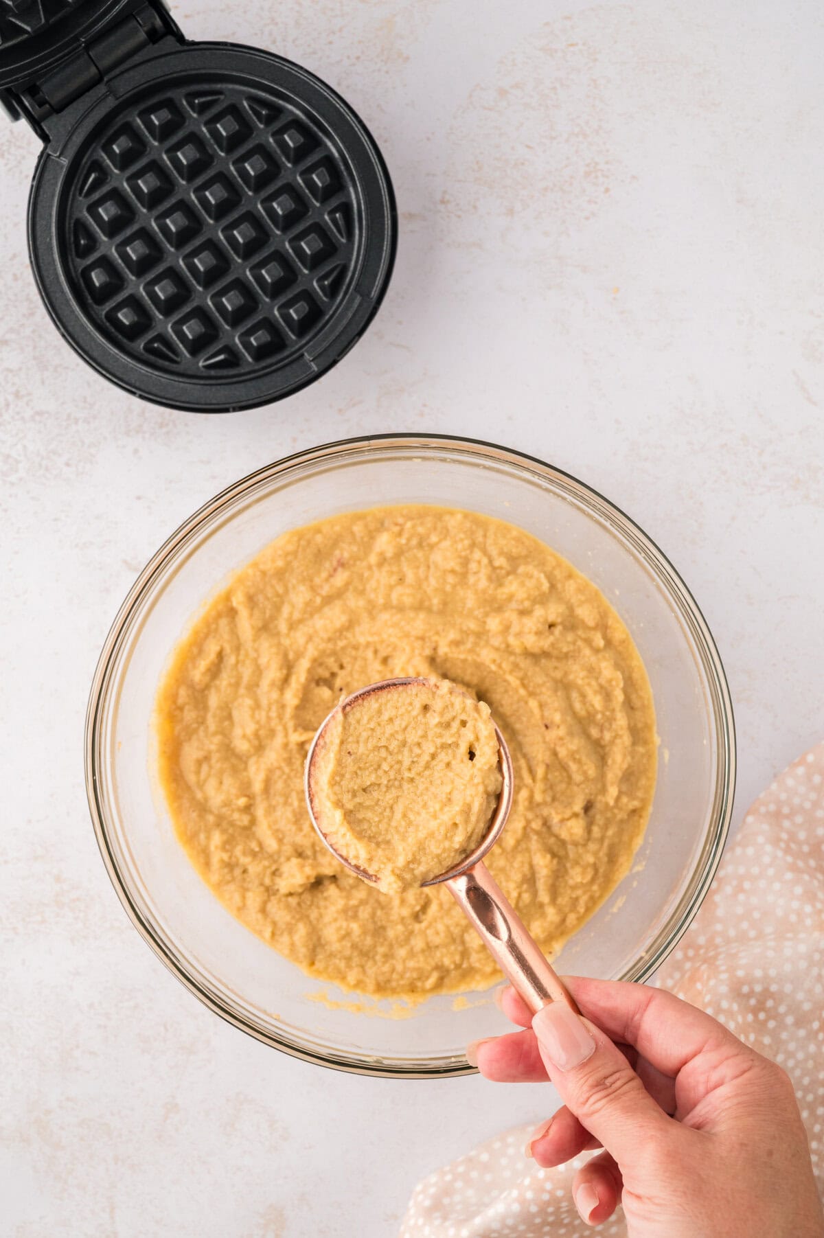 Waffle batter in measuring cup.