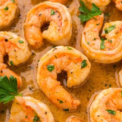 Close up of lemon pepper shrimp in skillet.