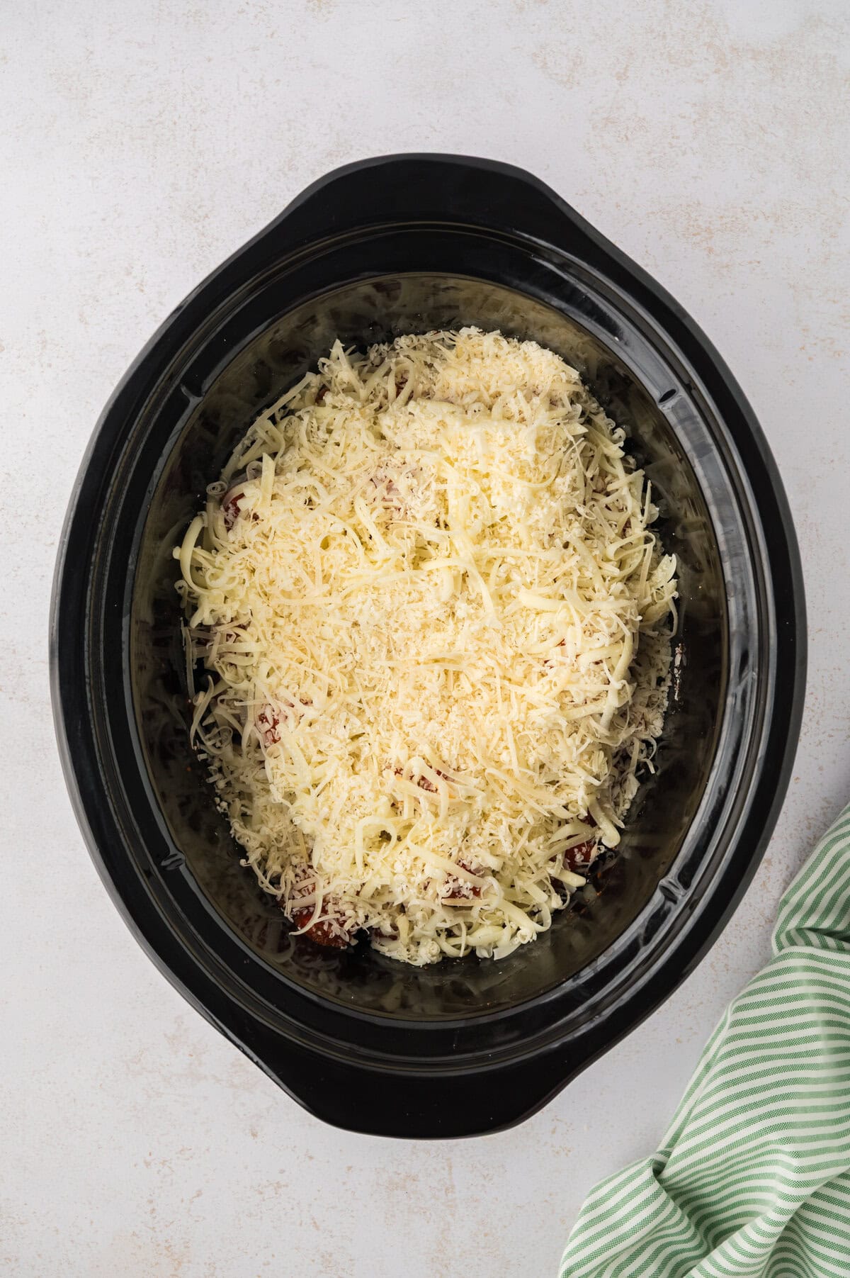 Mozzarella cheese in slow cooker with meatballs.