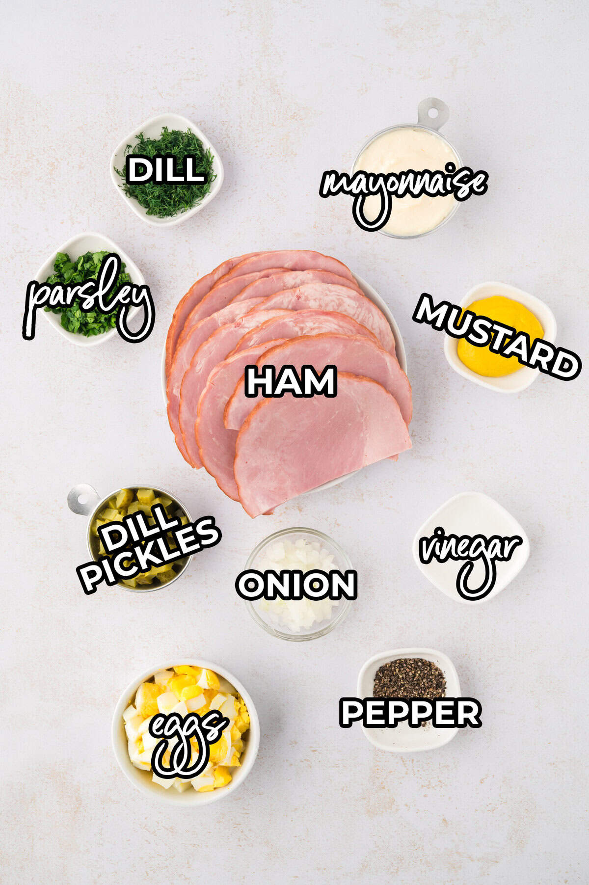 Ingredients for dill pickle ham salad recipe laid out on counter.