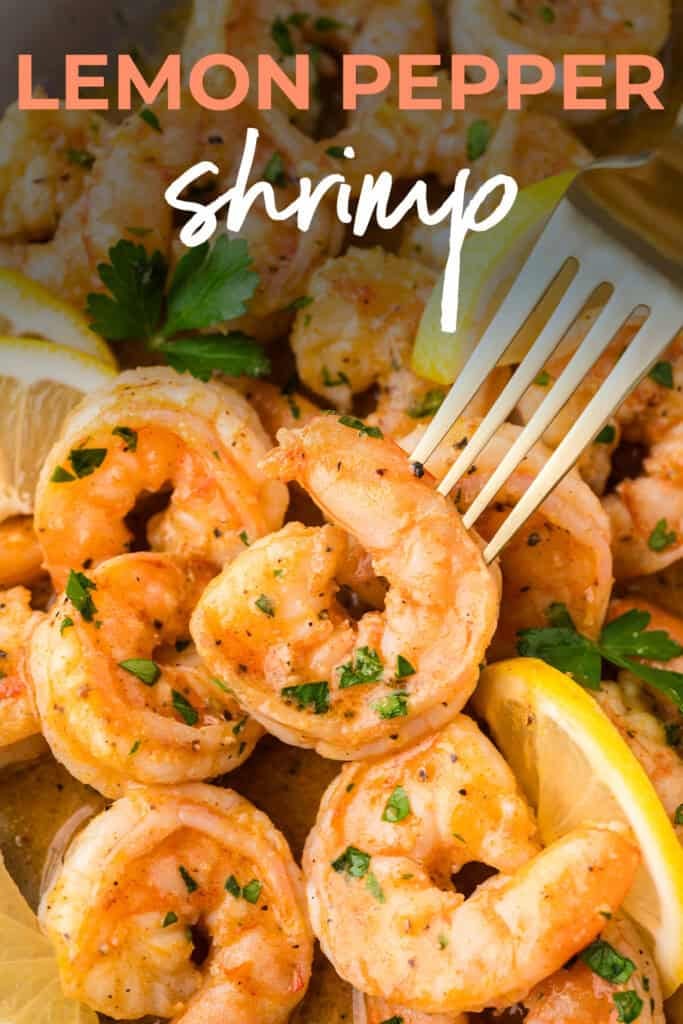 Shrimp on fork with lemon wedges.