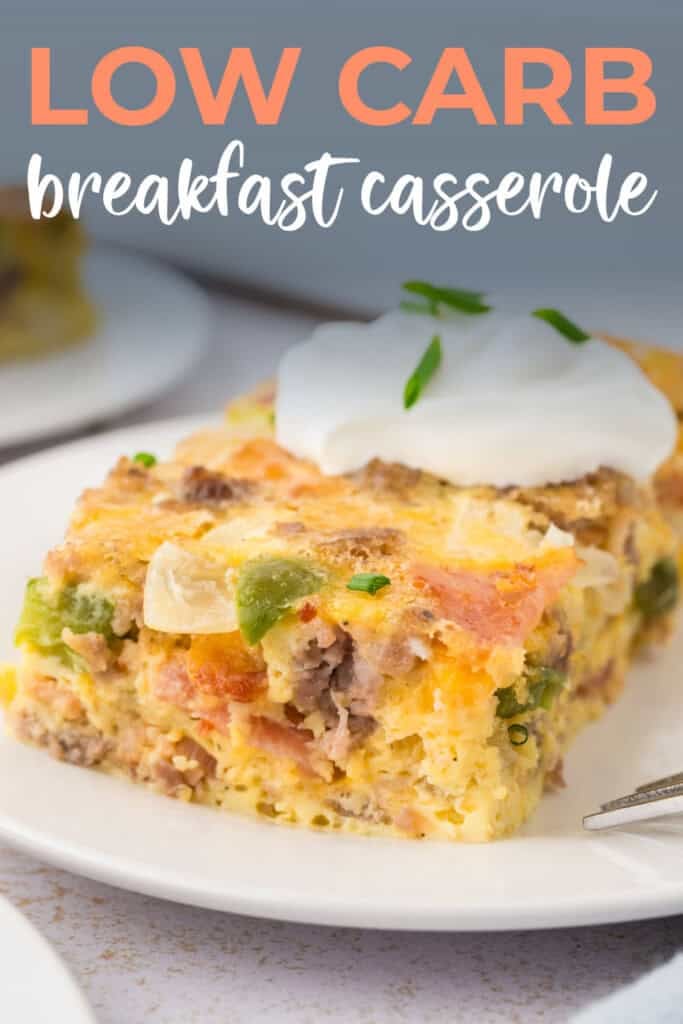 Breakfast casserole on plate with sour cream on top.