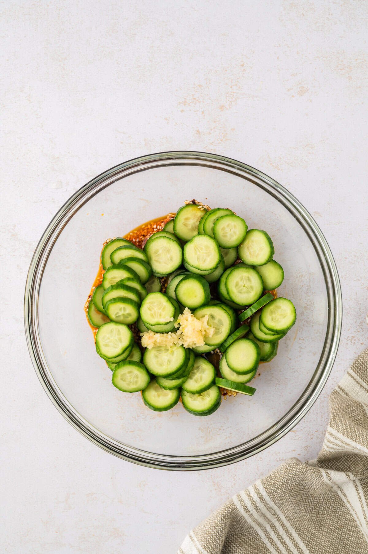 Cucumbers in bowl of dressing.