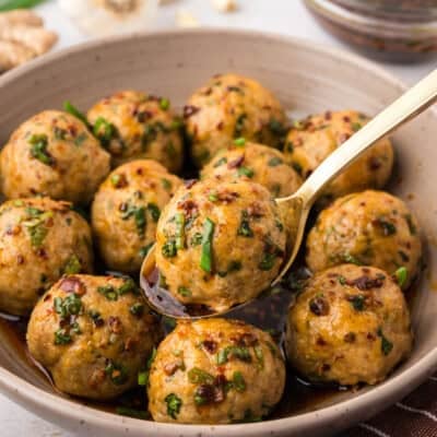Bowl full of low carb turkey meatballs in Asian sauce.