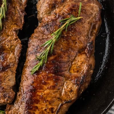 Seared steak in cast iron skillet.