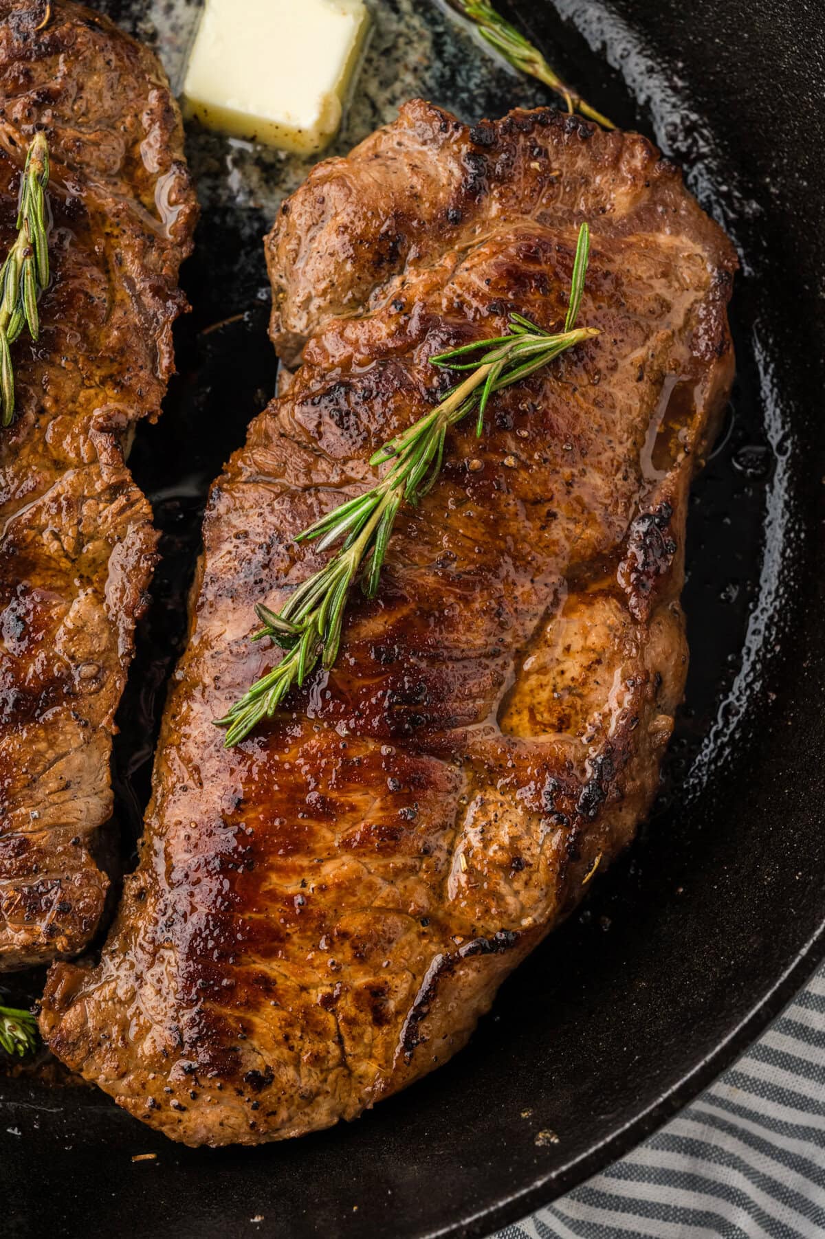Seared steak in cast iron skillet.