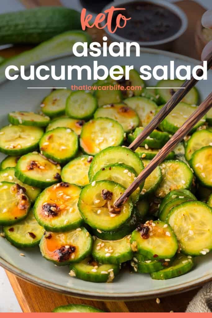 Chopsticks picking up pieces of cucumber salad.