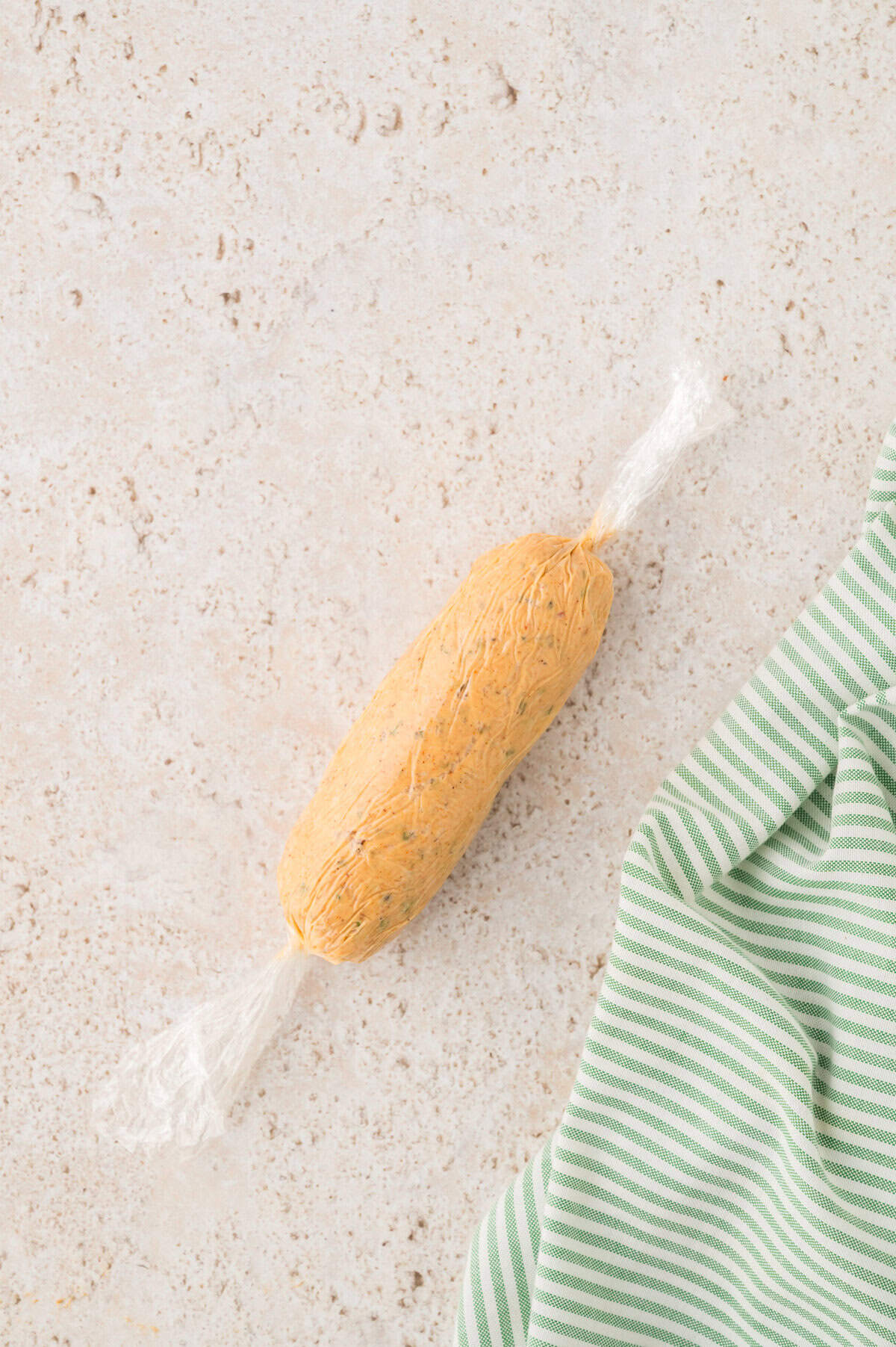 Log of cowboy butter in plastic wrap.