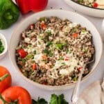 Keto stuffed pepper skillet with beef, peppers, and cauliflower rice in bowl.