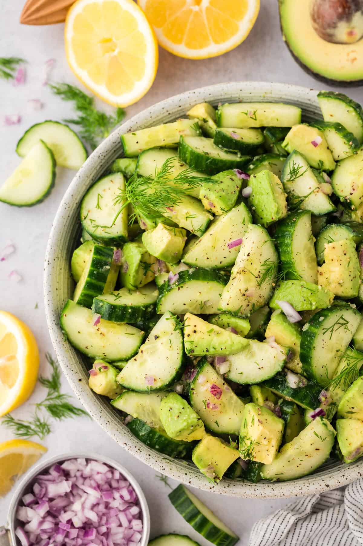 Overhead view of cucumber avocado salad in serving dish.