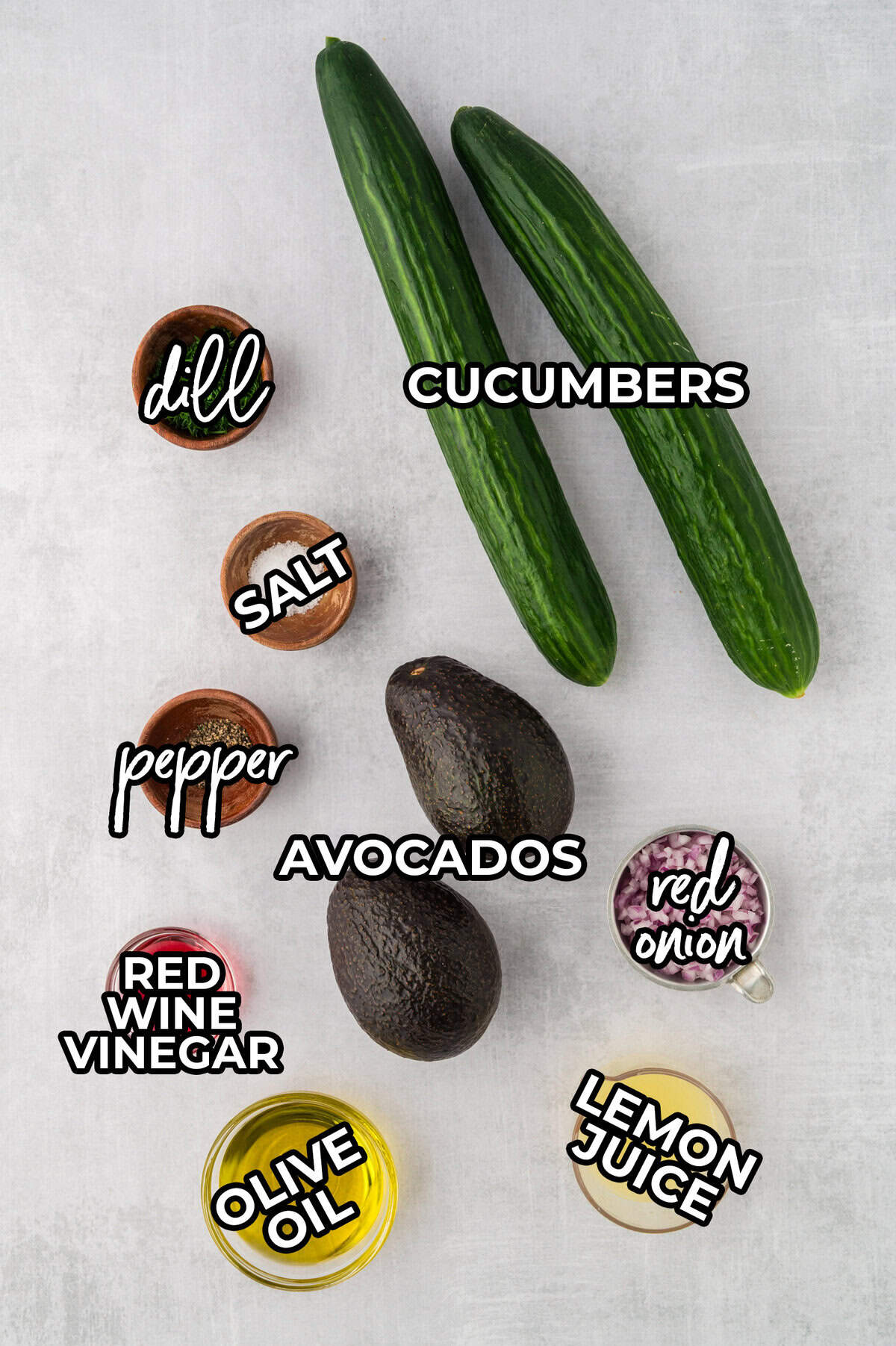 Ingredients for cucumber avocado salad on countertop.