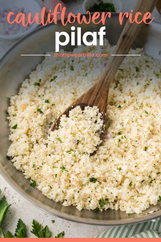 Wooden spoon in pan full of cauliflower rice pilaf.