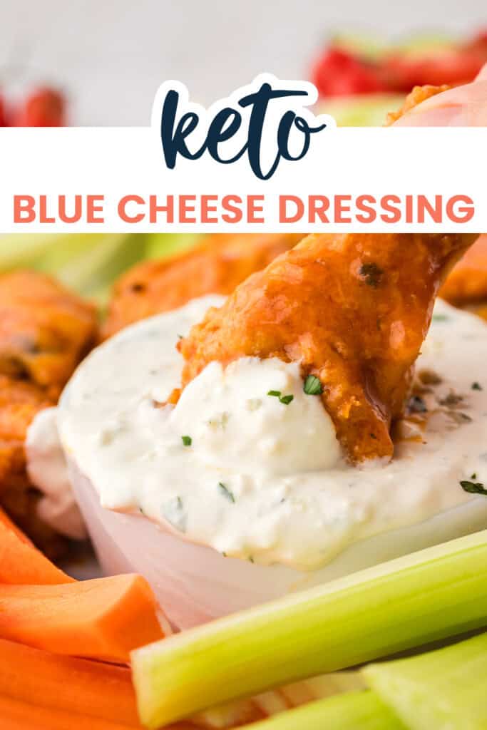 Buffalo wing being dipped in keto blue cheese dressing.
