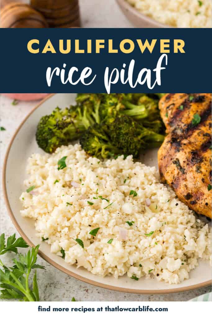 Cauliflower rice pilaf on plate with broccoli and chicken.