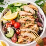 Salad topped with Greek grilled chicken recipe.