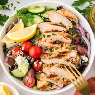 Salad topped with Greek grilled chicken recipe.
