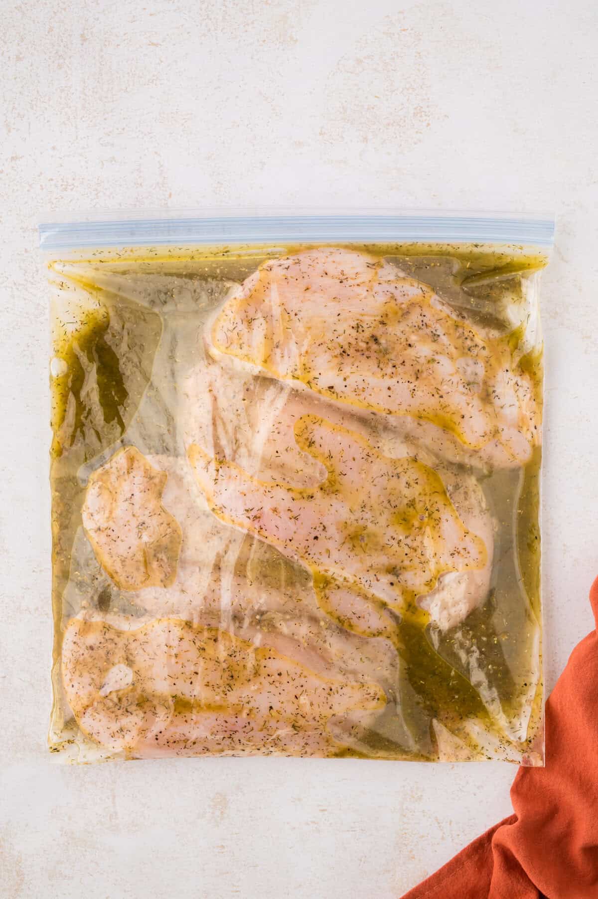 Chicken breasts in ziptop bag with Greek marinade.