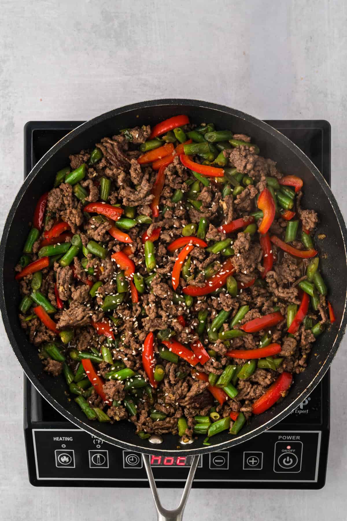 Ground beef stir fry in skillet.