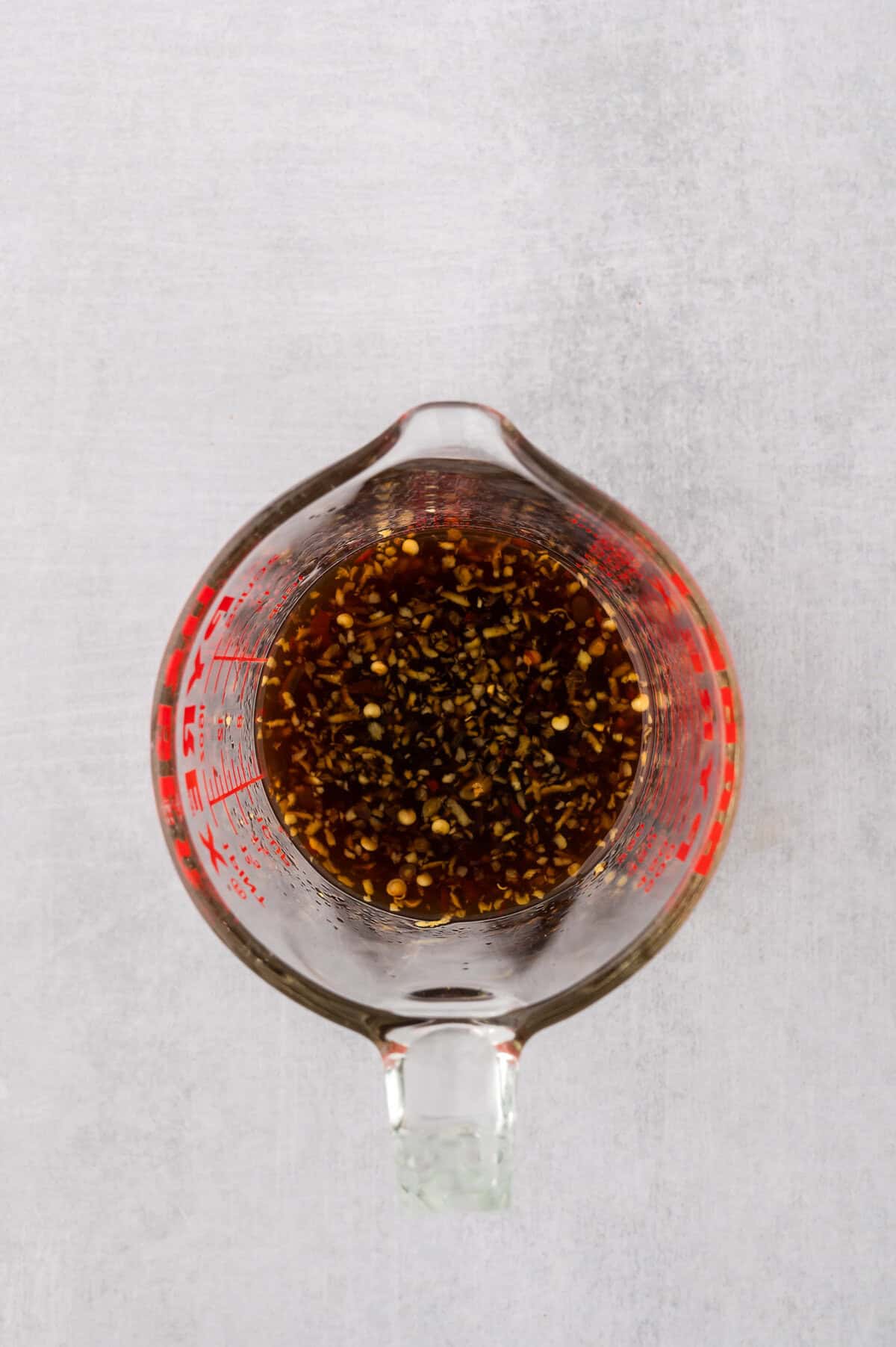 Soy ginger sauce whisked together in measuring cup.