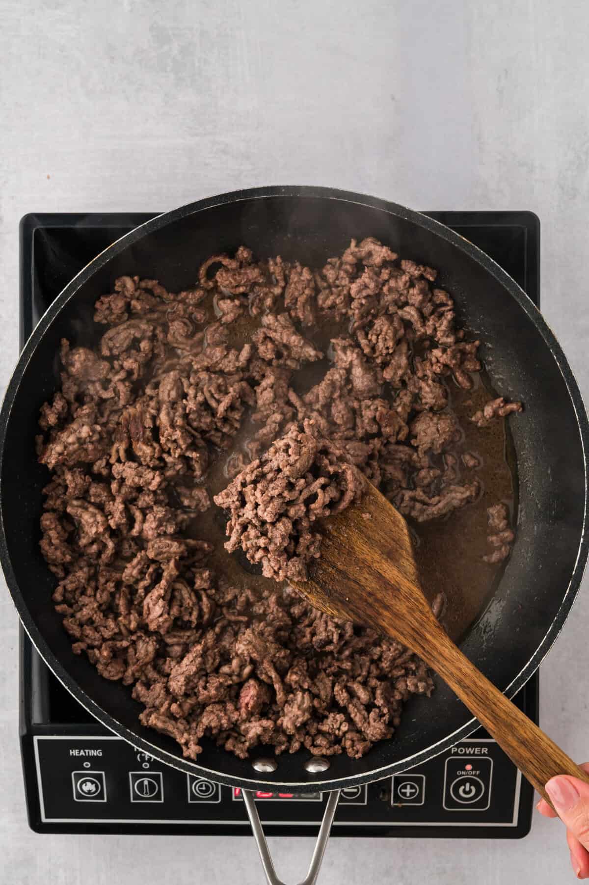 Seared ground beef in skillet.