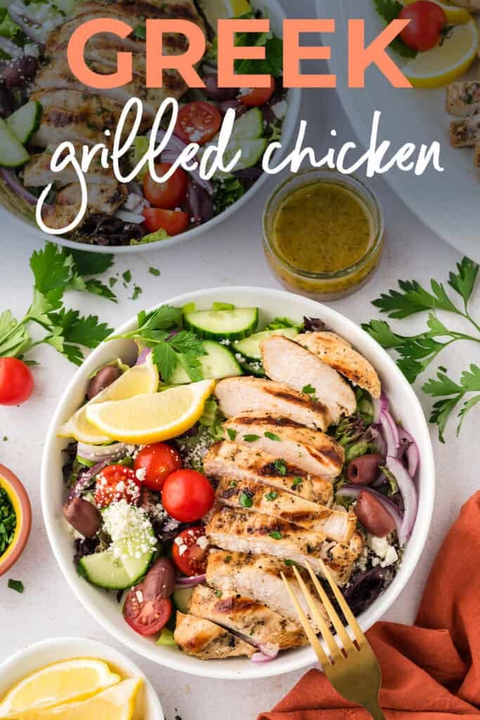 Sliced Greek chicken over salad.