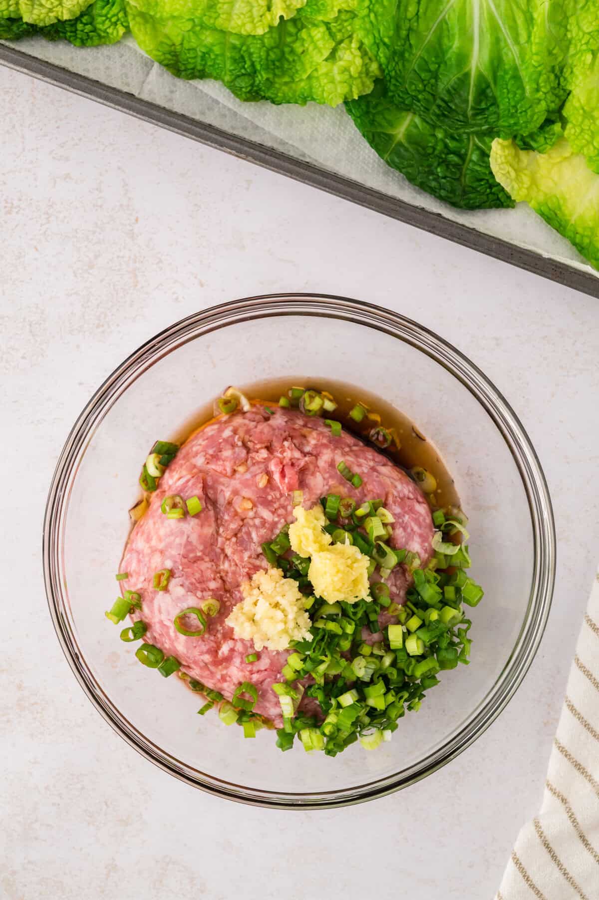 Filling for cabbage dumplings in glass mixing bowl.