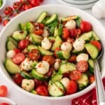 White bowl filled with cucumber tomato salad recipe.