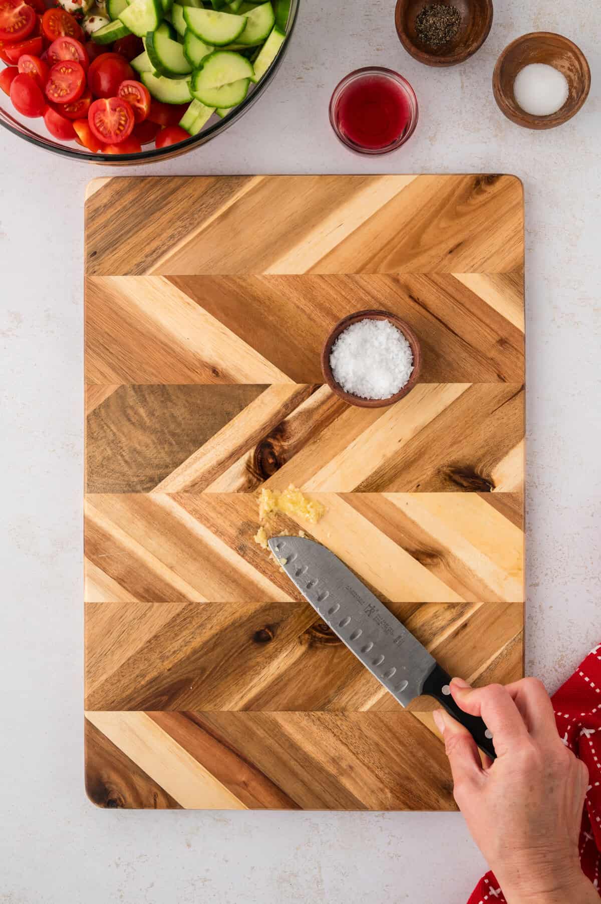 Garlic being pasted with a knife.