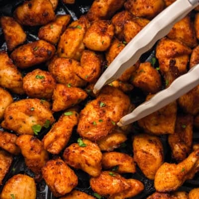 Keto chicken bites in air fryer basket.