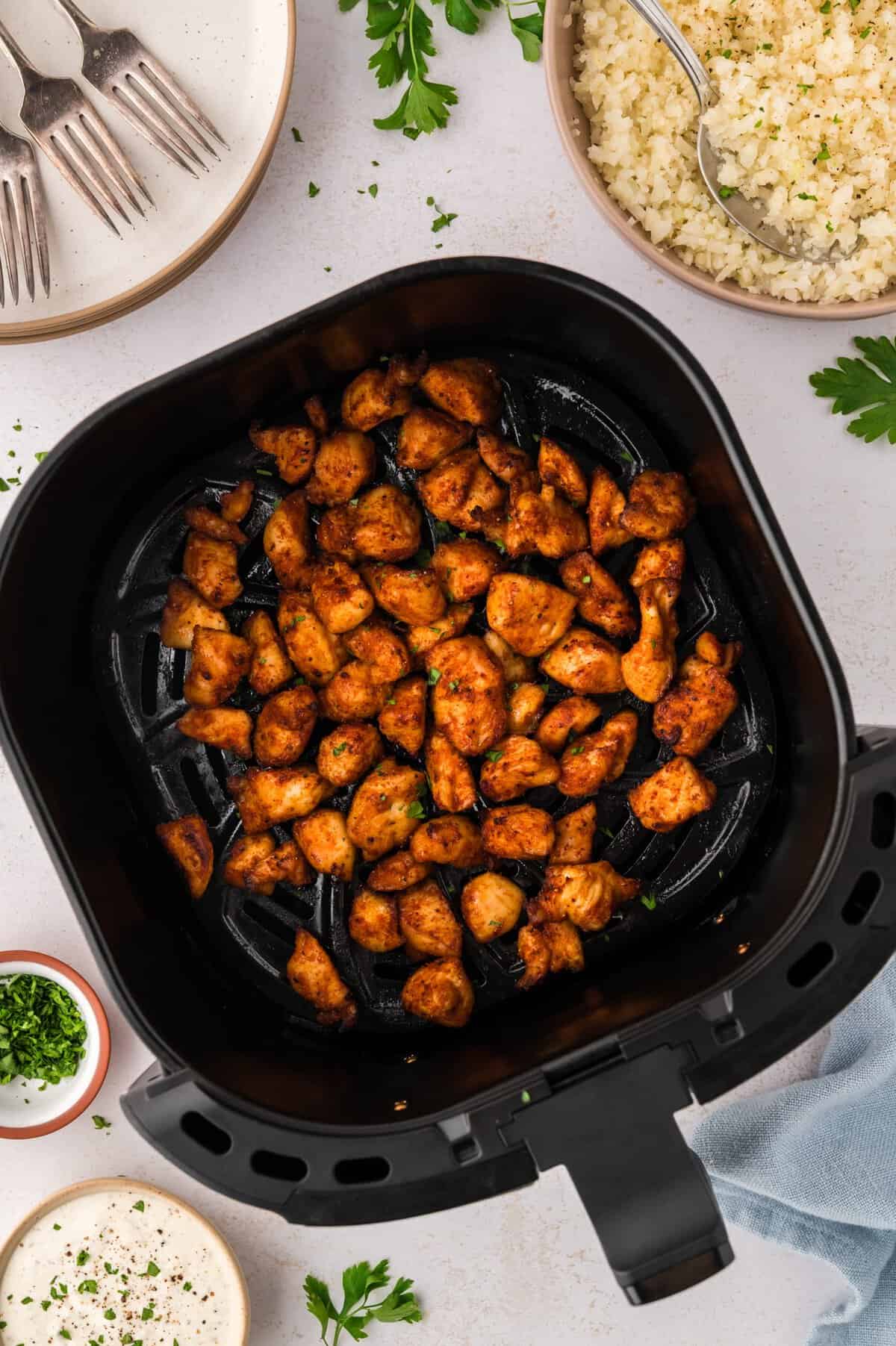 Air fried chicken bites in basket.