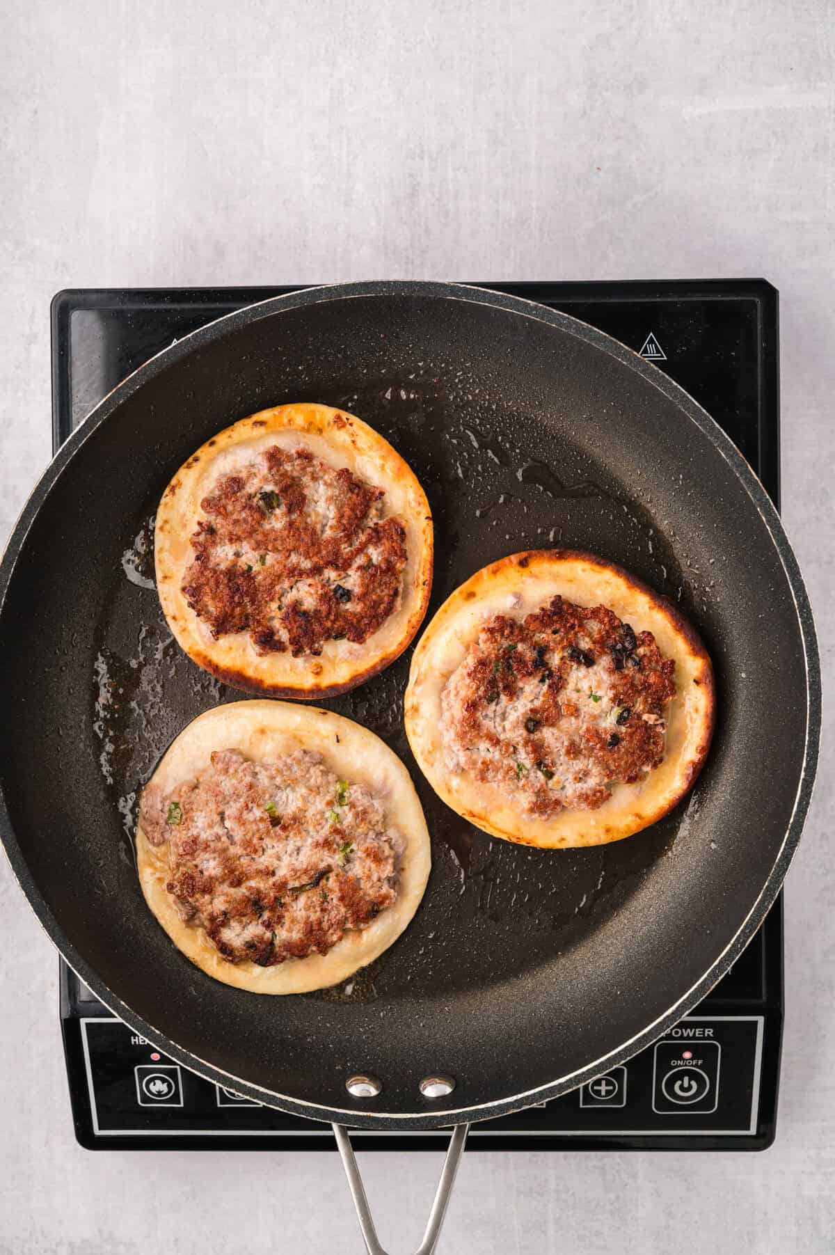 Keto egg roll tacos being cooked in skillet.