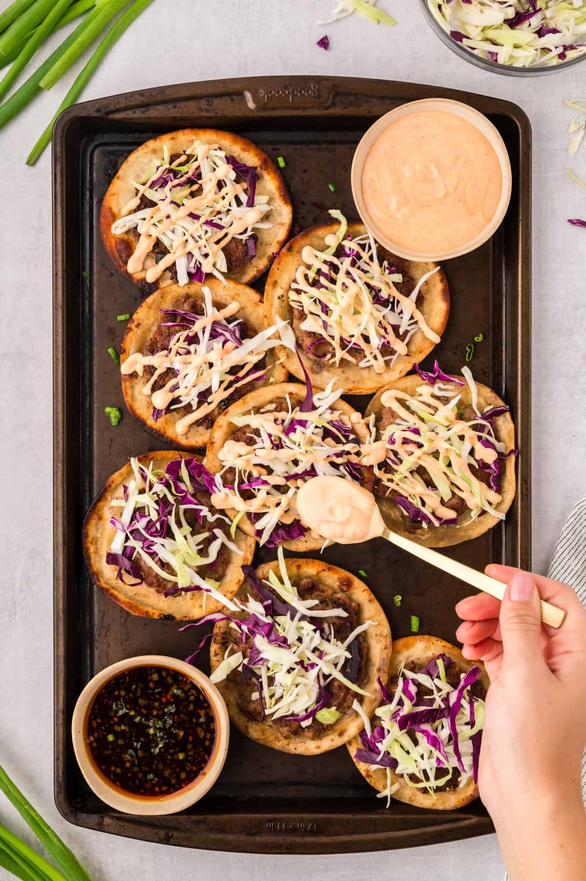 Spicy mayo being drizzled over keto egg roll tacos.