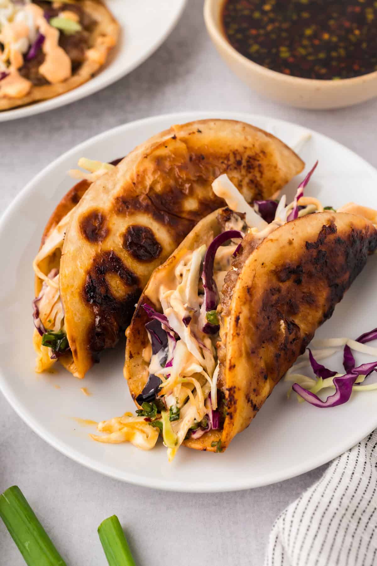 Smashed egg roll tacos on plate.