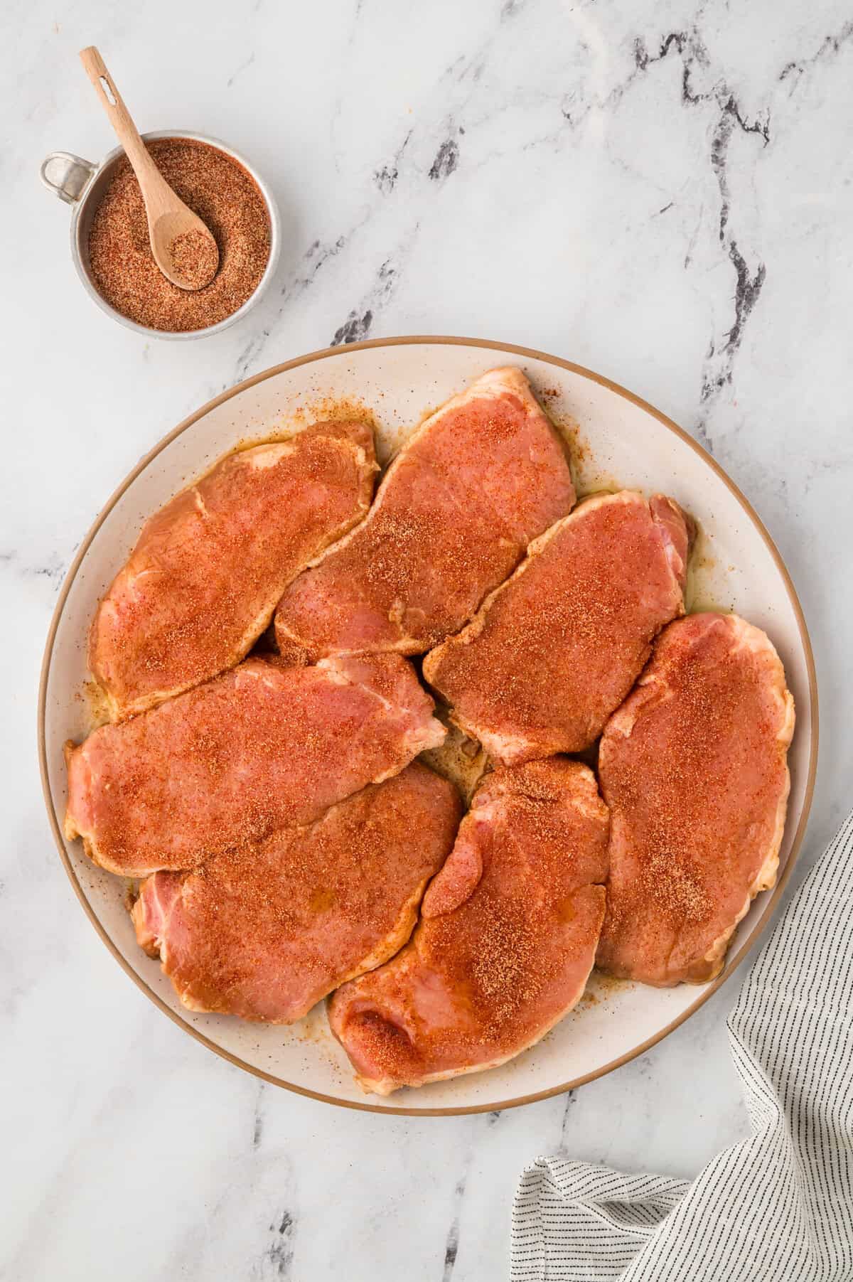 Pork chops coated in seasoning.