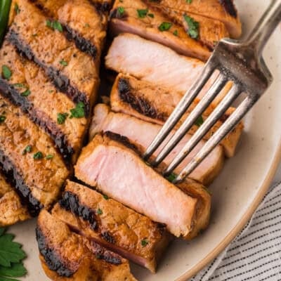 Grilled pork chop on plate.