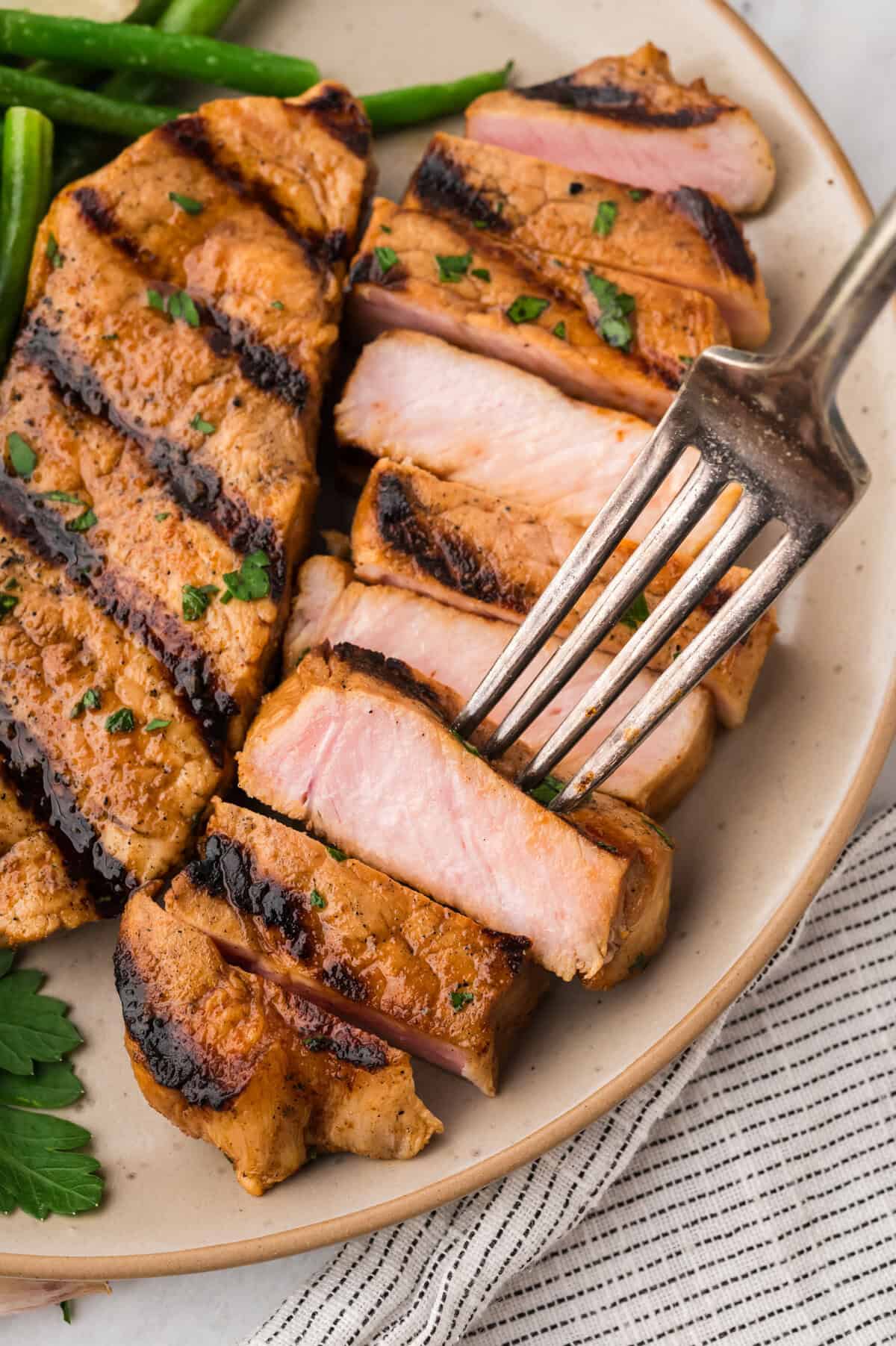 Grilled pork chop on plate.