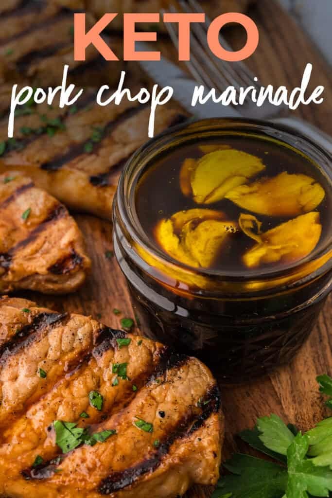 Pork chop marinade in mason jar surrounded by grilled pork chops.