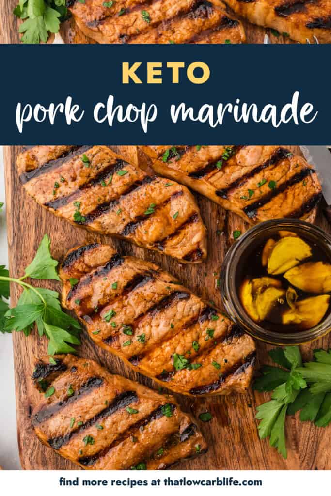 Grilled pork chops on wooden cutting board.